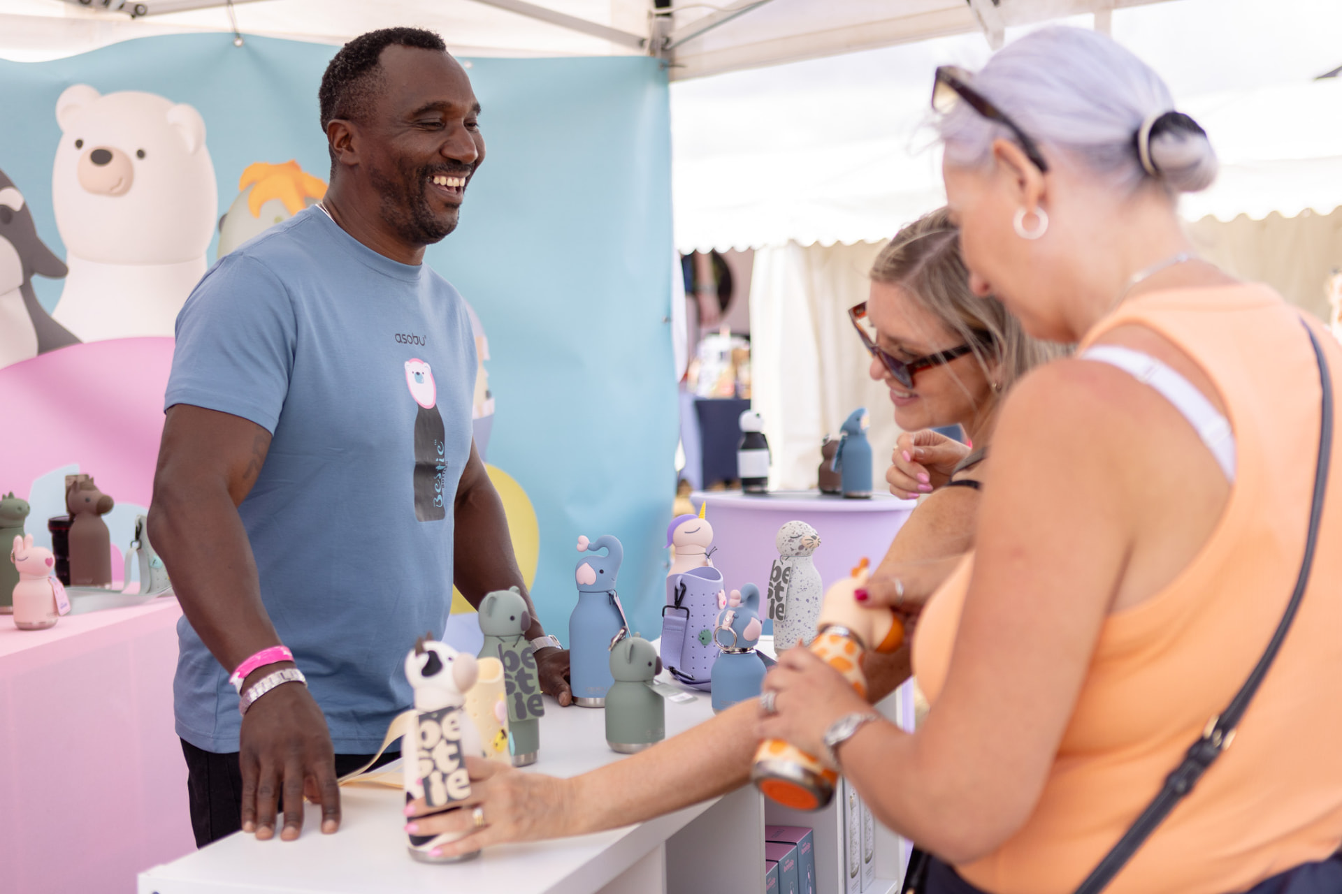 Hello Consumer salespeople talking to customers on an exhibition stand